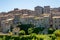 Little medieval town skyline of Grotte di Castro, Lazio, Italy, with blue sky in background