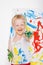 Little messy kid painting with paintbrush picture on easel. Education. Creativity. School. Preschool. Studio portrait over white