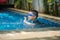 Little mix Asian Arab boy swimming at swimming pool outdoor activity