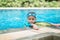 Little mix Asian Arab boy swimming at swimming pool outdoor activity