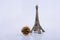 Little model Eiffel Tower and pine cone