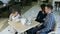 Little modern girl takes photos of her lovely parents in cafe.