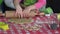 Little mother helper girl is helping to roll dough batter on kitchen table