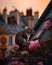 Little mouse in a chimney on the roofs of Paris with beautiful pink flowers.