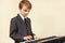 Little musician in suit playing the electronic synthesizer