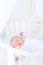 Little newborn baby boy sleeping in white round crib