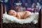 Little newborn baby boy, sleeping in wooden baby bed with little chick