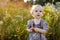 Little nice baby walking in a meadow