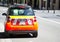 Little NSW Ambulance smart car parking on downtown street of Sydney.