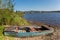 Little old rowing boat on the shore of lake Lipno