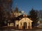 Little orthodox church with gold criests on winter eveninbg