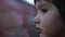 Little passenger looks through window from train. Portrait of a boy looking at freight train through train`s window