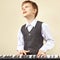 Little pianist play the keys of synthesizer