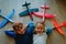 Little pilots- happy kids with helmet and glasses play with toy planes