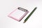 Little pink paper clipboard. short note to paper with pencil. office equipment. blank paper clipboard for task checklist. holding