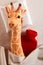 Little plush toy giraffe running a fever