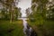 Little pond in forest flows to the lake