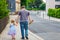 Little preschool girl and father walking in the city. Happy toddler child and man holding hands. Happy family, bonding