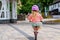 Little preschool girl with helmet running with balance bike on summer day. Happy child driving, biking with bicycle