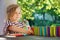 Little preschool girl playing board game with colorful bricks domino. Happy child build tower of wooden blocks