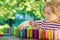 Little preschool girl playing board game with colorful bricks domino. Happy child build tower of wooden blocks