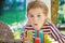 Little preschool girl playing board game with colorful bricks domino. Happy child build tower of wooden blocks