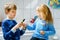 Little preschool girl and preteen school boy brushing teeth. Brother teaching sister brush teeth. Happy siblings. Two