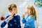 Little preschool girl and preteen school boy brushing teeth. Brother teaching sister brush teeth. Happy siblings. Two