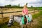 Little preschool girl riding a pony on a farm. Happy lovely child practicing horseback riding. Outdoor summer activities
