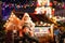 Little preschool girl sitting on shoulder of father on Christmas market in Germany. Happy toddler child and man
