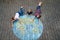 Little preschool girl and two school kids boys with earth globe painting with colorful chalks on ground. Happy earth day