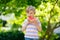 Little preschool kid boy eating watermelon in summer