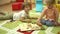 Little preschool kids playing with educational toys in kindergarten