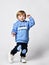 Little preschool toddler boy in in trendy sportive outwear studio headshot