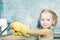 Little preschooler girl makes kitchen dishes cleaning