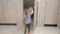 Little preschooler girl with ponytail opens toilet door