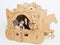 Little princess in crown 7 years old play in carriage made of brown cardboard