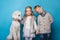 Little princess and handsome boy with Royal poodle. Love. Friendship. Family. Studio portrait over blue background