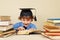 Little professor in academic hat reading old books