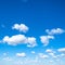 Little puffy clouds in blue sky in sunny day