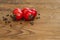Little red cherry tomatoes on wooden board background. Folded in a circle