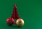 Little red christmas tree with tree adornments on green background