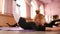 Little red-haired girl ballerina stretching and doing exercises in ballet school