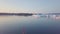 Little red sailboat cruising among floating icebergs in Disko Bay glacier during midnight sun season of polar summer. Greenland