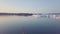 Little red sailboat cruising among floating icebergs in Disko Bay glacier during midnight sun season of polar summer. Ilulissat,