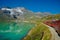 Little red train traveling in the Swiss mountains and connecting Switzerland with Italy