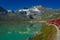 Little red train traveling in the Swiss mountains and connecting Switzerland with Italy