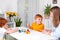 Little redhead boys with a nanny or mother or teacher sit at the table and paint with colors