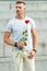 Little romance can enhance your love life. Man mature macho with romantic gift. Handsome guy with rose flower romantic
