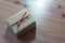 Little rustic gift box tied with green and red polka dot ribbons, on a diagonal, space for text